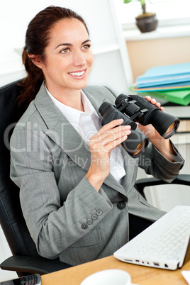 businesswoman holding binoculars