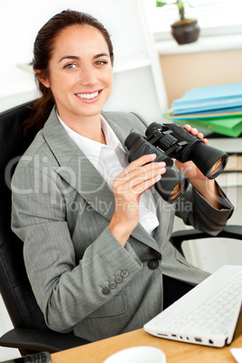 businesswoman holding binoculars
