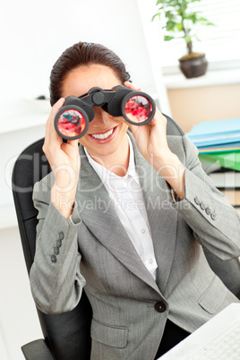 businesswoman looking through binoculars
