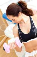 Athletic woman holding a dumbbell