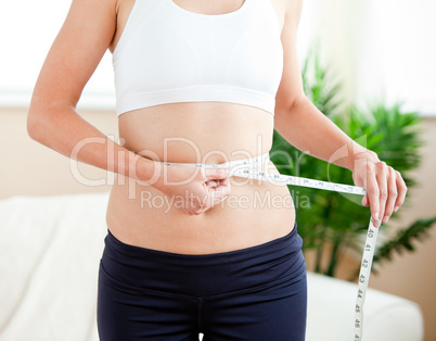 woman measuring her waist
