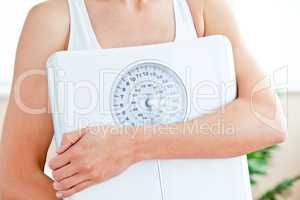 woman holding a scale