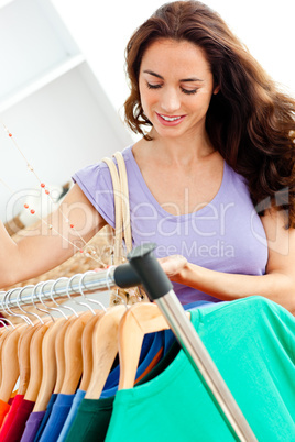Cute hispanic woman looking for clothes