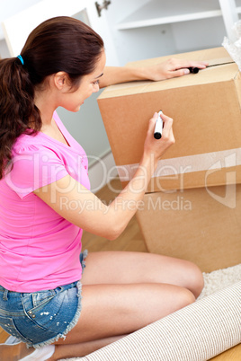 woman writing on a cardboard