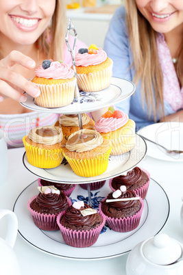 female friends eating pastries in the kitchen