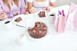 female friends eating a chocolate cake