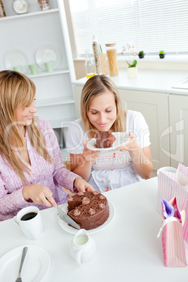 female friends eating a chocolate cake