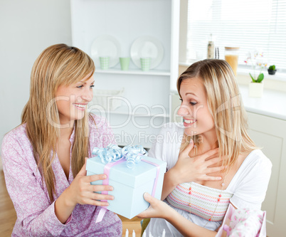 woman giving a present to her surprised friend