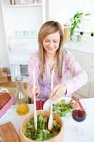 woman eating salad in the kitchen