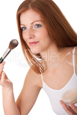 Body care series - Beautiful red hair woman applying powder