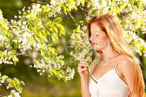 Young woman enjoying spring under blossom tree