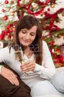 Brown hair woman sitting with glass of champagne on Christmas