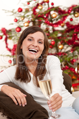 Brown hair woman sitting with glass of champagne on Christmas