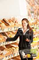 Grocery store: Business woman choosing bread
