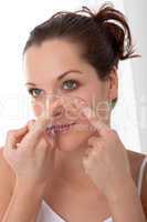 Body care series - Young woman applying contact lens