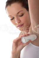 Body care series - Young woman applying deodorant