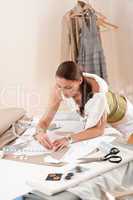 Female fashion designer working with sketches