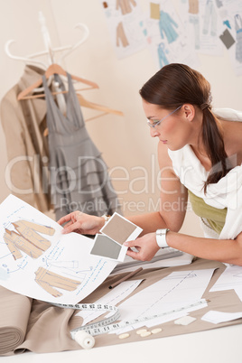 Female fashion designer working with sketches