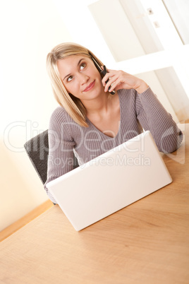 Student series - Blond woman using mobile phone and laptop