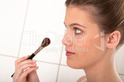 Body care series - Young woman applying powder