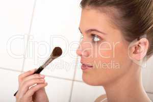 Body care series - Young woman applying powder