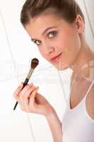 Body care series - Blond woman applying powder