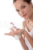 Body care series - Young woman with bottle of lotion