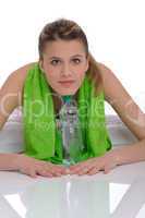 Fitness - Young sportive woman with water and towel