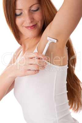 Body care series - Smiling red hair woman shaving her armpit