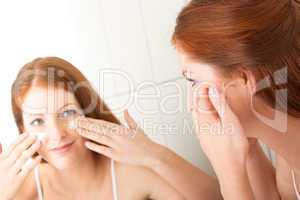 Body care series - Attractive young woman applying cream