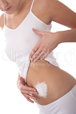 Body care series - Woman applying cream on  her belly