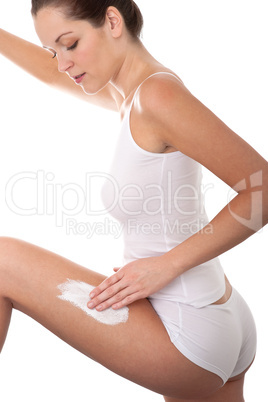 Body care series - Beautiful young woman applying cream on her l