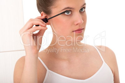 Body care series - young woman applying mascara