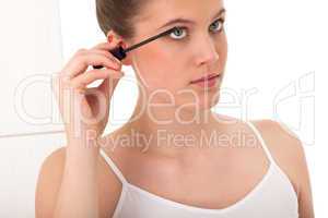 Body care series - young woman applying mascara