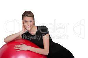 Fitness - Young woman with exercise ball on white