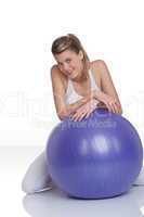 Fitness - Young woman with exercise ball on white