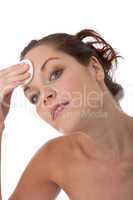 Body care series - Young woman cleaning her face with cotton pad