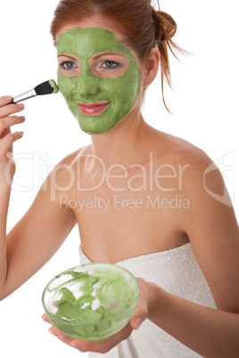 Body care series - Attractive woman applying green facial mask