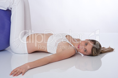 Fitness - Young woman with exercise ball on white