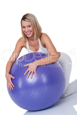 Fitness series - Blond smiling woman with purple ball