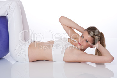 Fitness - Young woman with exercise ball on white