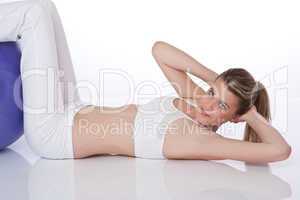 Fitness - Young woman with exercise ball on white