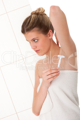 Body care series - Blond woman shaving her armpit