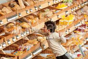 Grocery store shopping - Little boy buying bread