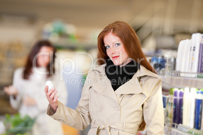 Shopping series - Red hair woman holding deodorant
