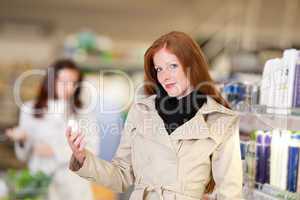 Shopping series - Red hair woman holding deodorant