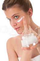 Body care series - blond woman applying cream
