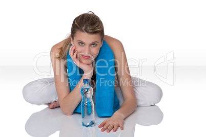 Fitness - Young sportive woman with water and towel