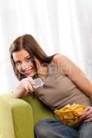 Students series - Smiling young woman watching television and ea