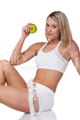 Fitness series - Blond woman in white outfit holding apple